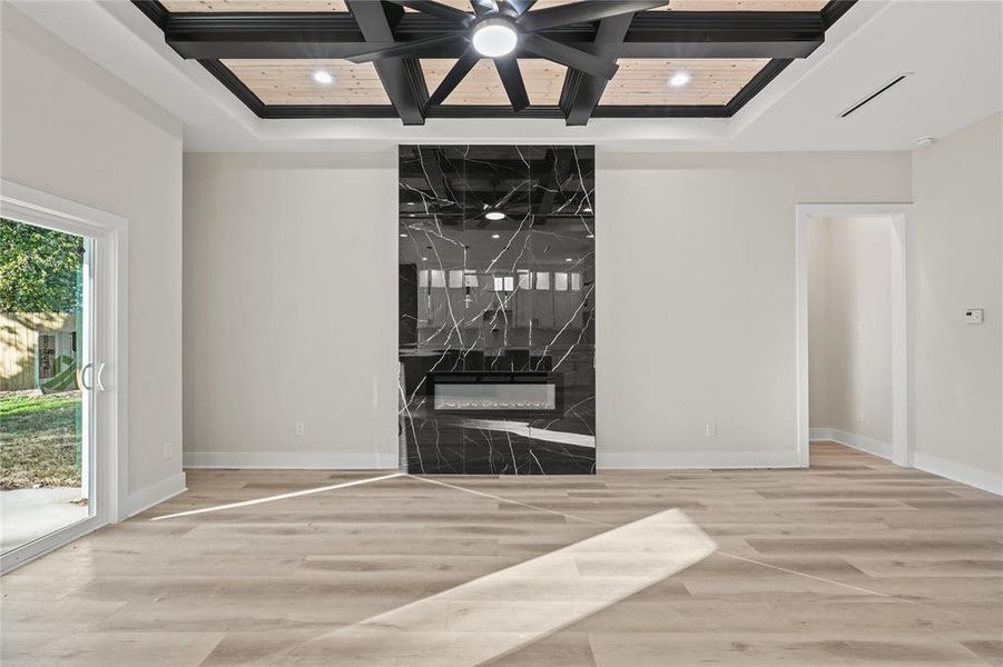 Unfurnished room with hardwood / wood-style flooring, a raised ceiling, and coffered ceiling