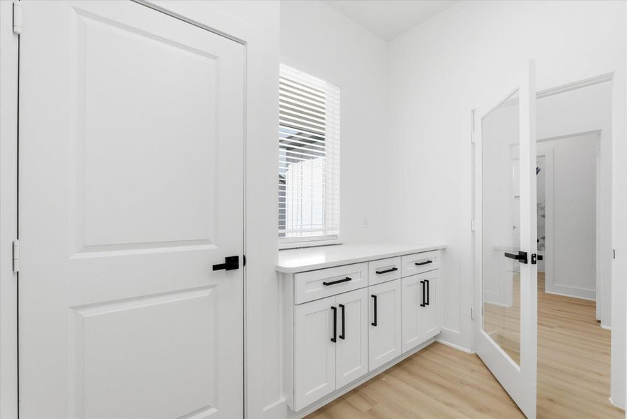 Stepping inside from the garage, you’ll find a mud area with built-in storage and plenty of natural light.