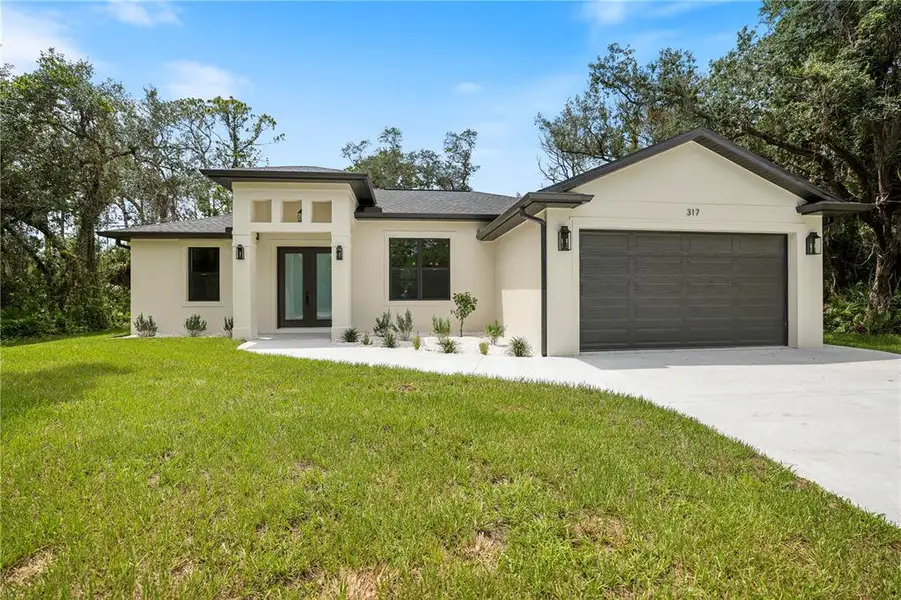 Front exterior of a new home in , Port Charlotte, FL, highlighting curb appeal (Image 19).