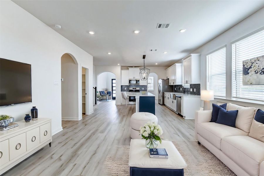 A beautifully designed open floor plan that seamlessly connects the kitchen, dining, and living spaces. Large windows flood the space with natural light, creating a bright and airy feel.**This is a picture of a Rylan Floor Plan from another Saratoga Homes.** A beautifully designed open floor plan that seamlessly connects the kitchen, dining, and living spaces. Large windows flood the space with natural light, creating a bright and airy feel.**This is a picture of a Rylan Floor Plan from another Saratoga Homes.**