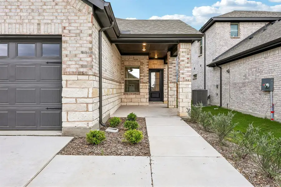 Exterior details and patio area of a home in Parks at Foster Crossing - Spring Series, Anna (Image 3).