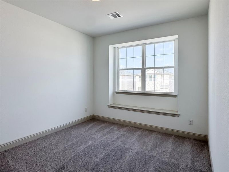 Spare room featuring visible vents, baseboards, and carpet