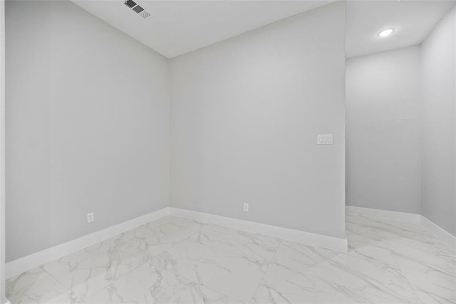 Unfurnished room featuring visible vents, baseboards, and marble finish floor