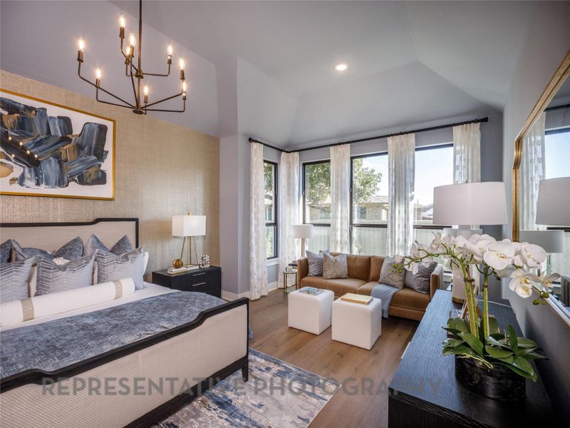 Bedroom featuring multiple windows, a chandelier, wood finished floors, an accent wall, and wallpapered walls