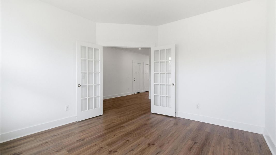 Superior craftsmanship meets practical luxury in this accomplished French door home office at the Foxbank community