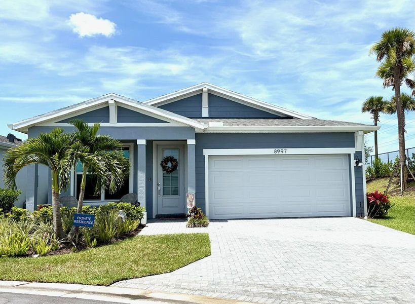 Front exterior of a new home in Tradition - Kenley, Port St. Lucie, FL, highlighting curb appeal (Image 1). Front exterior of a new home in Tradition - Kenley, Port St. Lucie, FL, highlighting curb appeal (Image 1).
