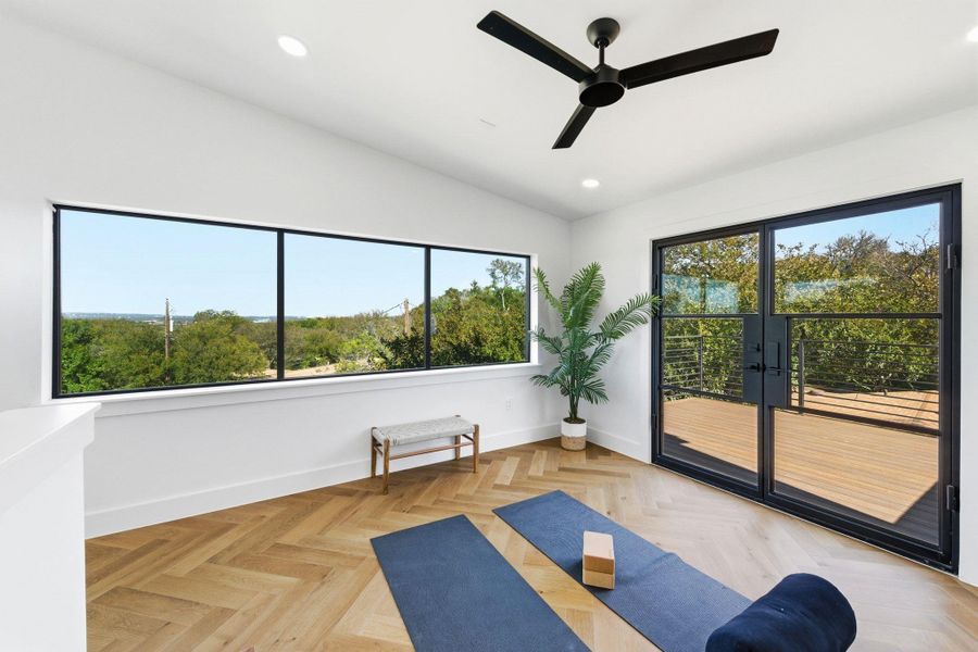 3rd floor workout/office area with vaulted ceiling, recessed lighting, and a ceiling fan plus 2nd private deck with tree top views