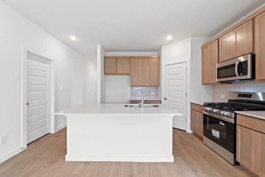 Kitchen in the Pearl home plan by Trophy Signature Homes – REPRESENTATIVE PHOTO