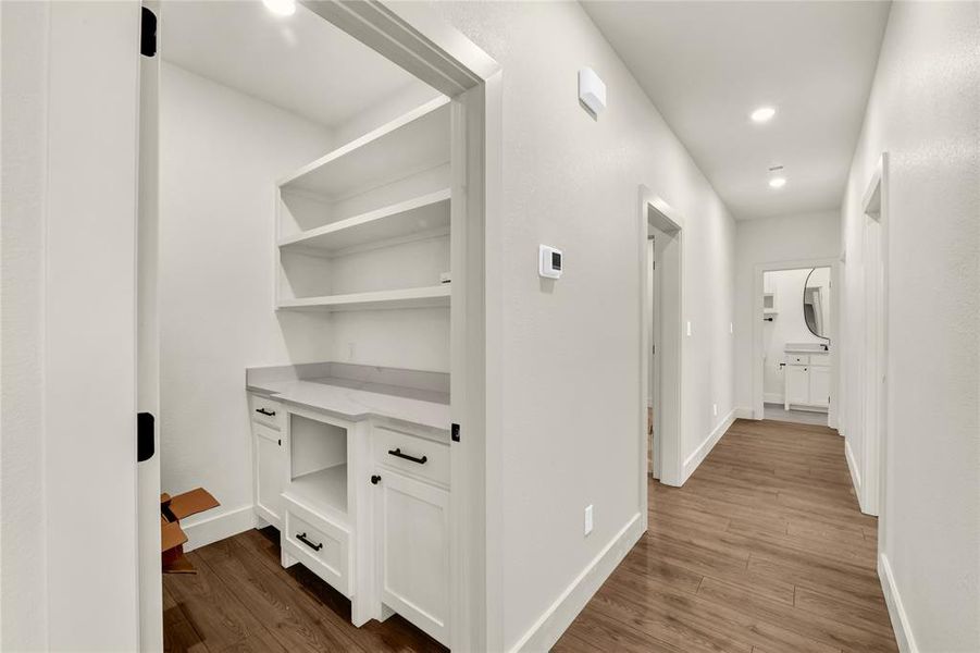 Corridor with dark wood-type flooring and recessed lighting Corridor with dark wood-type flooring and recessed lighting