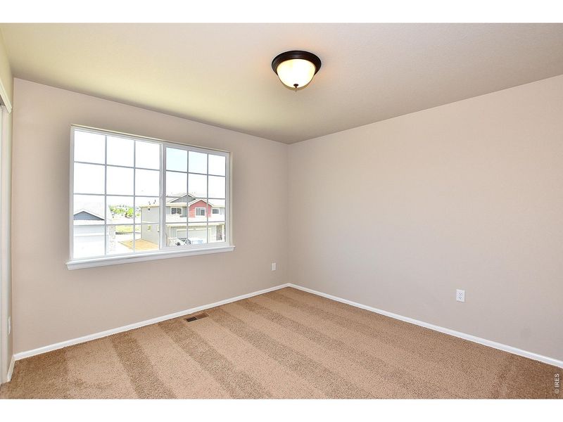 Spacious, unfurnished interior of a new home in Union Colony West, Greeley (Image 32).