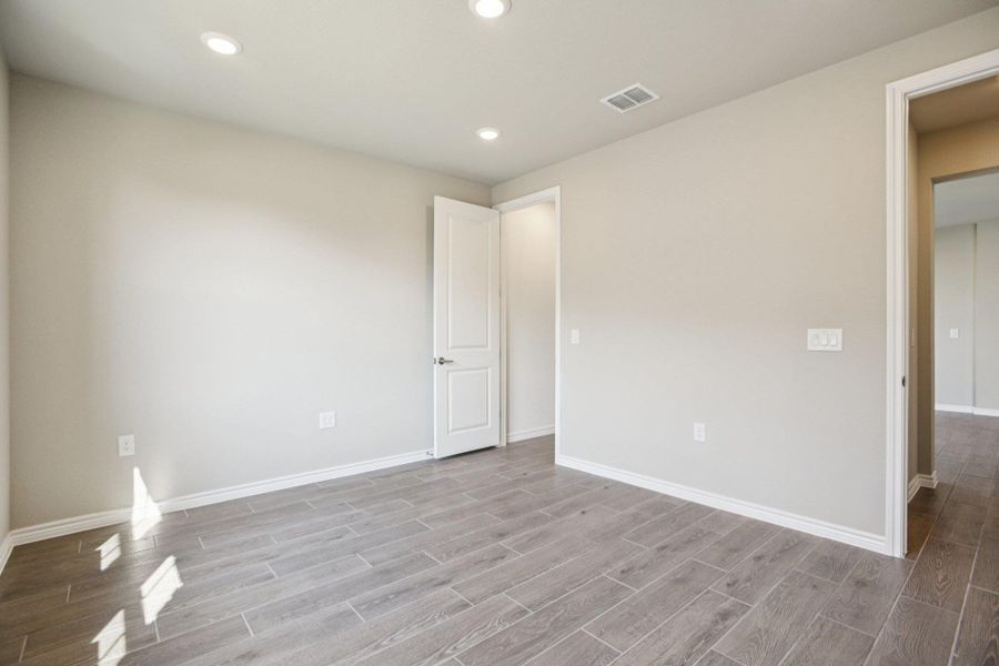 Unfurnished bedroom with recessed lighting and wood finish floors