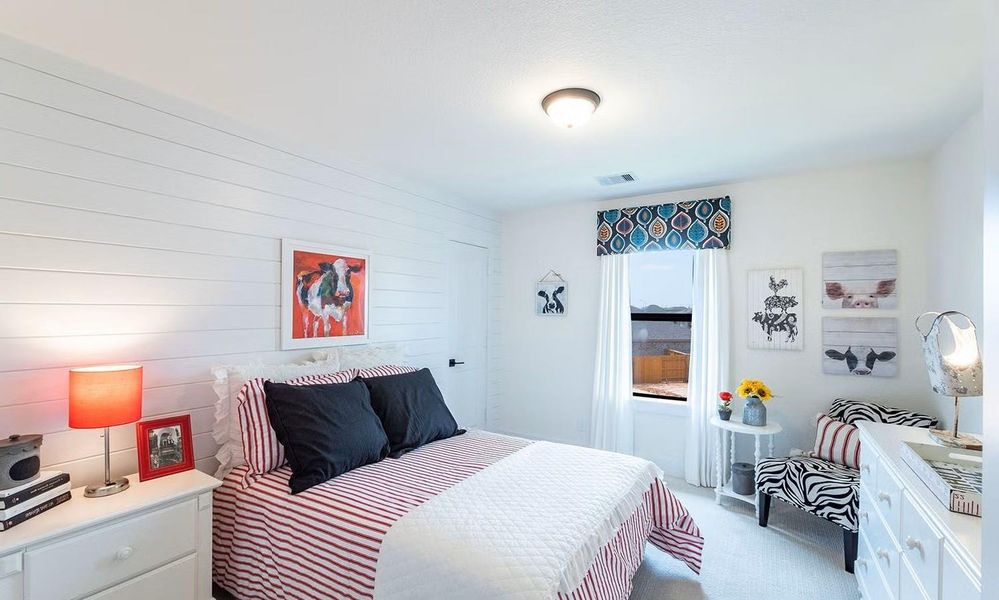 Bright secondary bedroom offering a comfortable layout with space for furnishings and personal touches, ideal for family members or guests. **Photos are representative only and may vary as built.**