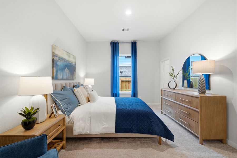 A bedroom with a bed and a dresser. A bedroom with a bed and a dresser.