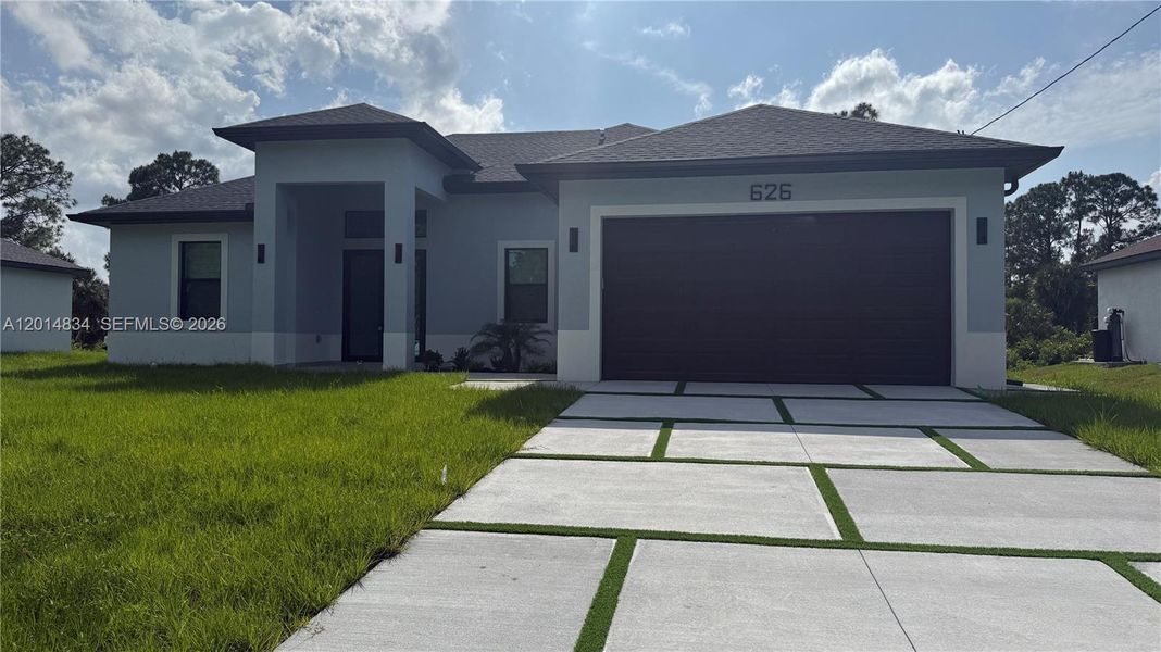 Front exterior of a new home in , Lehigh Acres, FL, highlighting curb appeal (Image 33).