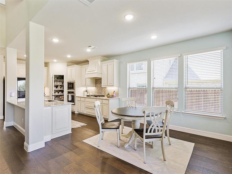 Dining space featuring sink and dark hardwood / wood-style floors