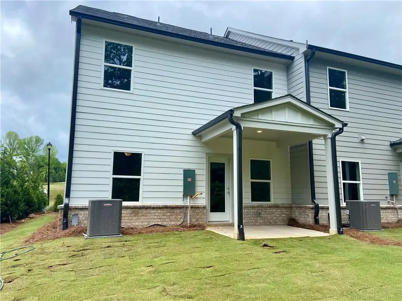 Exterior details and patio area of a home in Eastlyn Crossing, Flowery Branch (Image 3).