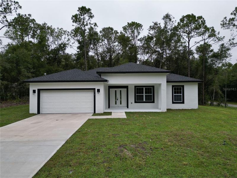 Front exterior of a new home in , Citrus Springs, FL, highlighting curb appeal (Image 28).
