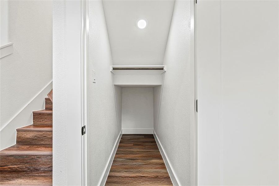 Stairway featuring wood finished floors