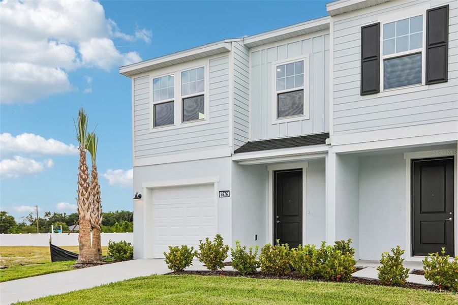 Front exterior of a new home in Twin Oaks, Zephyrhills, FL, highlighting curb appeal (Image 1). Front exterior of a new home in Twin Oaks, Zephyrhills, FL, highlighting curb appeal (Image 1).