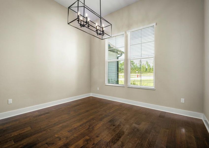 Formal dining room with wood floors.