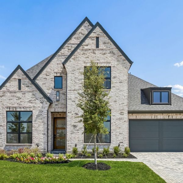 Front exterior of a new home in StarView, Prosper, TX, highlighting curb appeal (Image 25). Front exterior of a new home in StarView, Prosper, TX, highlighting curb appeal (Image 25).