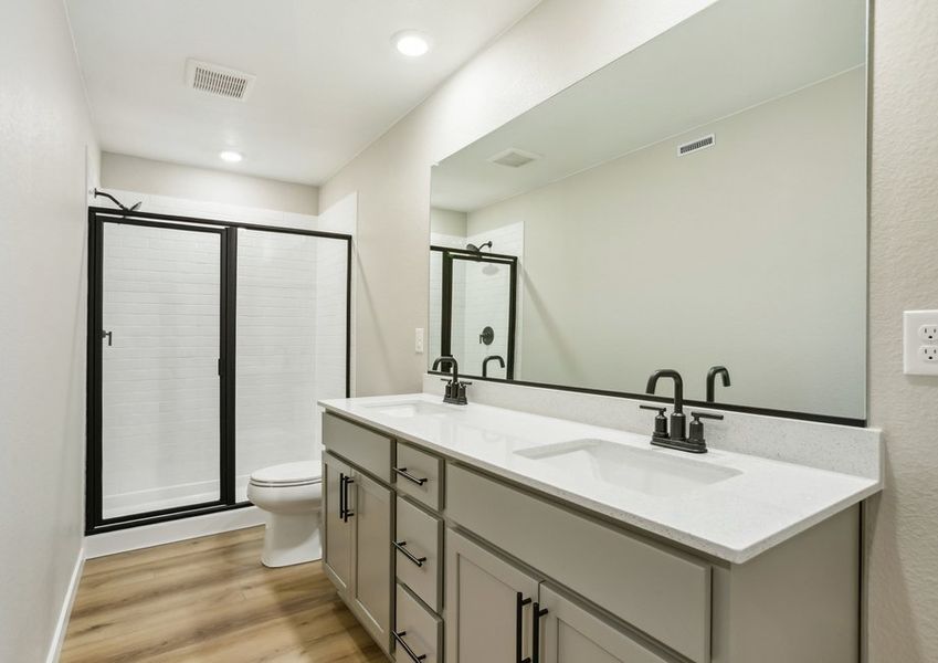 The master bathroom has a large vanity and a step in shower.