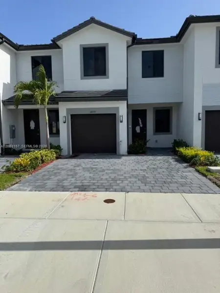 Front exterior of a new home in , Homestead, FL, highlighting curb appeal (Image 1). Front exterior of a new home in , Homestead, FL, highlighting curb appeal (Image 1).