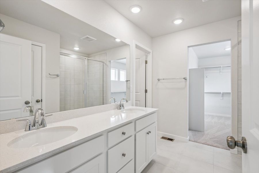 A bathroom with a glass shower. A bathroom with a glass shower.