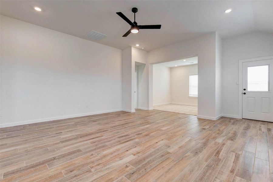 Enjoy the spaciousness of this open living area, designed for both comfort and versatility. High ceilings and recessed lighting enhance the airy feel, while the seamless connection to the kitchen creates an ideal environment for entertaining. The neutral finishes and wide layout provide endless possibilities for furniture arrangement and personalization.