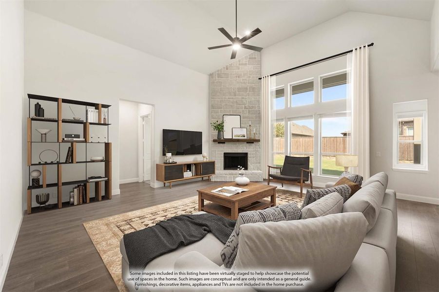 Living room with vaulted ceiling, stone fireplace, hardwood floors, and large windows letting in natural light. Living room with vaulted ceiling, stone fireplace, hardwood floors, and large windows letting in natural light.