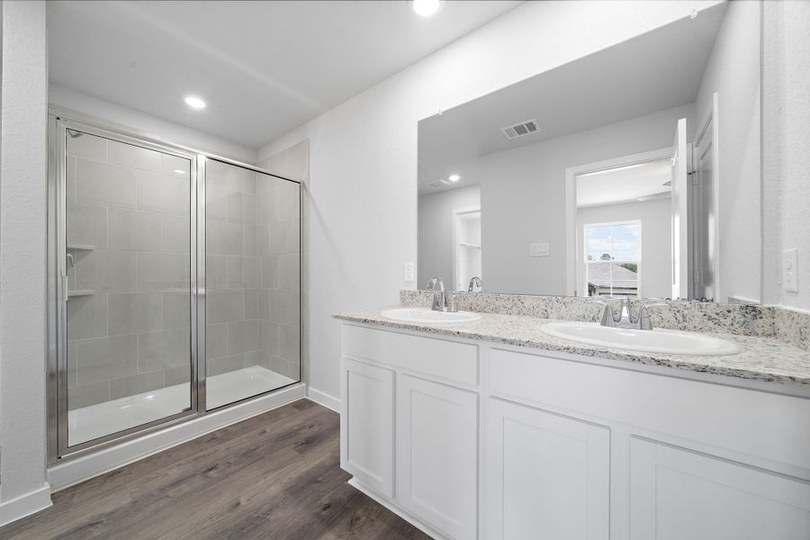 A bathroom with a glass shower. A bathroom with a glass shower.