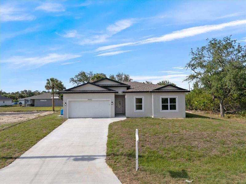 Front exterior of a new home in , Port Charlotte, FL, highlighting curb appeal (Image 2). Front exterior of a new home in , Port Charlotte, FL, highlighting curb appeal (Image 2).
