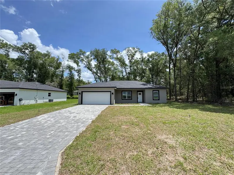 Front exterior of a new home in , Citrus Springs, FL, highlighting curb appeal (Image 18).