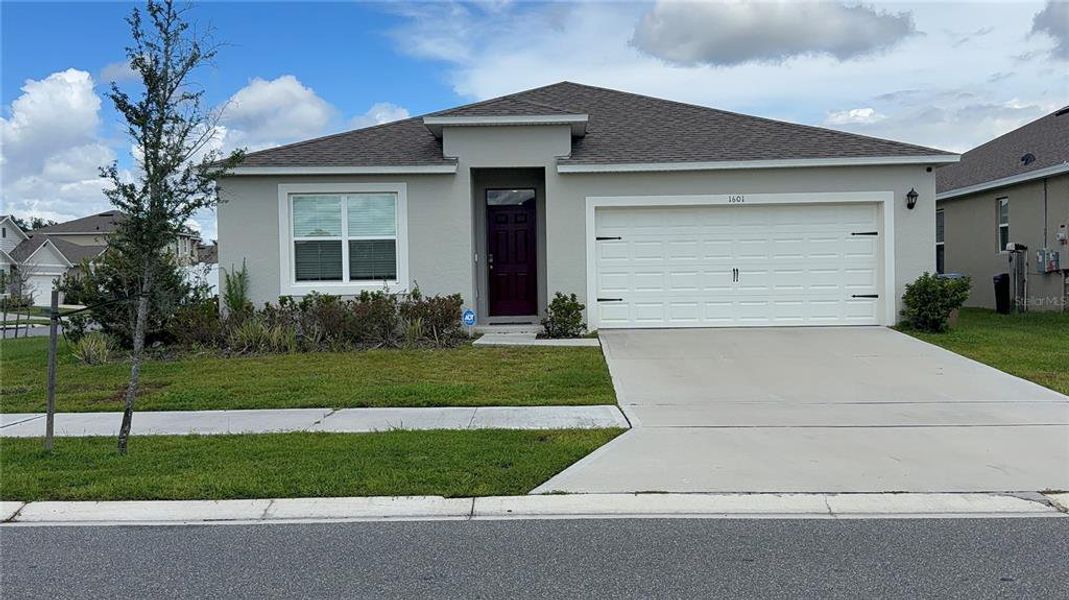 Front exterior of a new home in , Kissimmee, FL, highlighting curb appeal (Image 2).