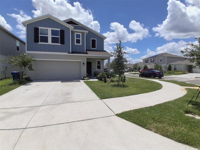 Front exterior of a new home in Hunt Club Groves, Lake Wales, FL, highlighting curb appeal (Image 2).