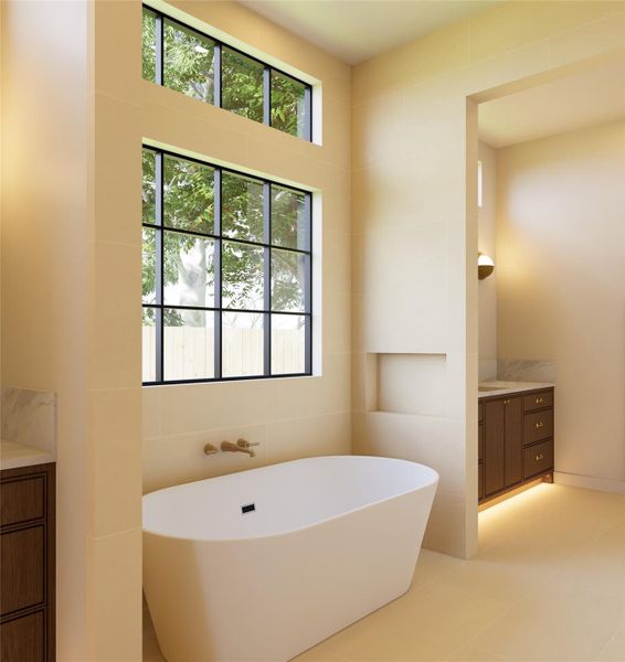Positioned beneath expansive windows, this sculptural soaking tub becomes a moment of pause where natural light, soft tones, and quiet surroundings create a truly restorative escape.