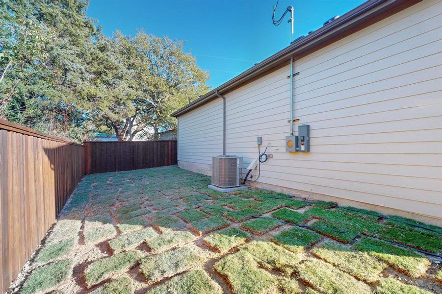 View of property exterior with cooling unit and a lawn