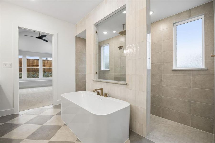 You'll enjoy a spa like experience every day in this luxurious owner's bath featuring freestanding tube and double walk through shower.