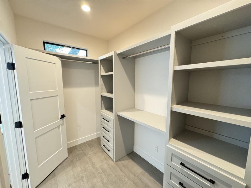 Spacious closet featuring light wood-type flooring Spacious closet featuring light wood-type flooring