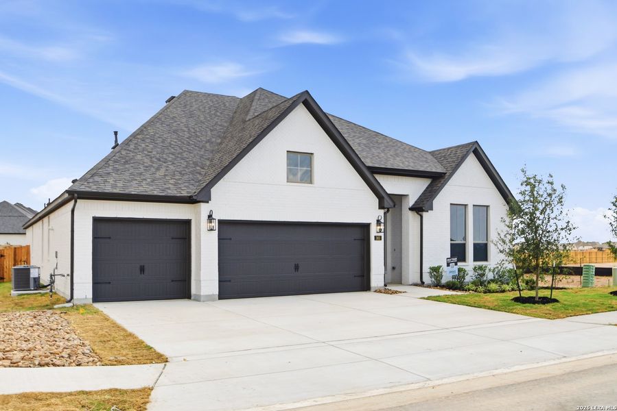 Front exterior of a new home in Legacy at Lake Dunlap, New Braunfels, TX, highlighting curb appeal (Image 2). Front exterior of a new home in Legacy at Lake Dunlap, New Braunfels, TX, highlighting curb appeal (Image 2).
