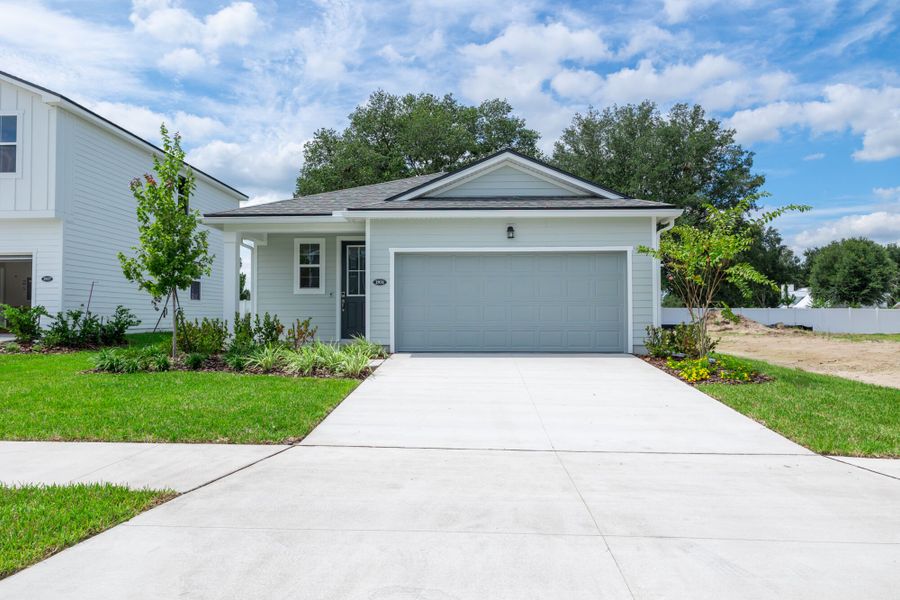 Front exterior of a new home in Sandridge Hills, Green Cove Springs, FL, highlighting curb appeal (Image 1). Front exterior of a new home in Sandridge Hills, Green Cove Springs, FL, highlighting curb appeal (Image 1).