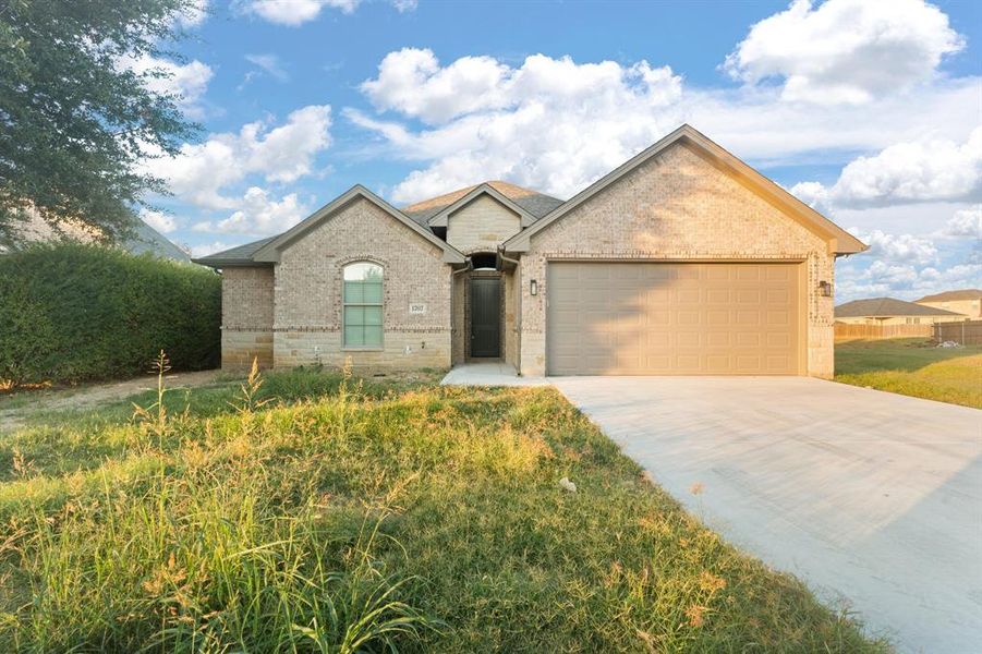 Front exterior of a new home in , Cleburne, TX, highlighting curb appeal (Image 1).