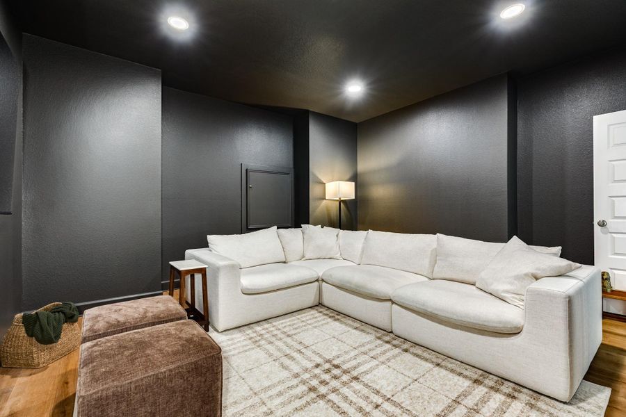 Media room featuring recessed lighting and rich wooden flooring, the perfect setup for movie nights and popcorn. Media room featuring recessed lighting and rich wooden flooring, the perfect setup for movie nights and popcorn.