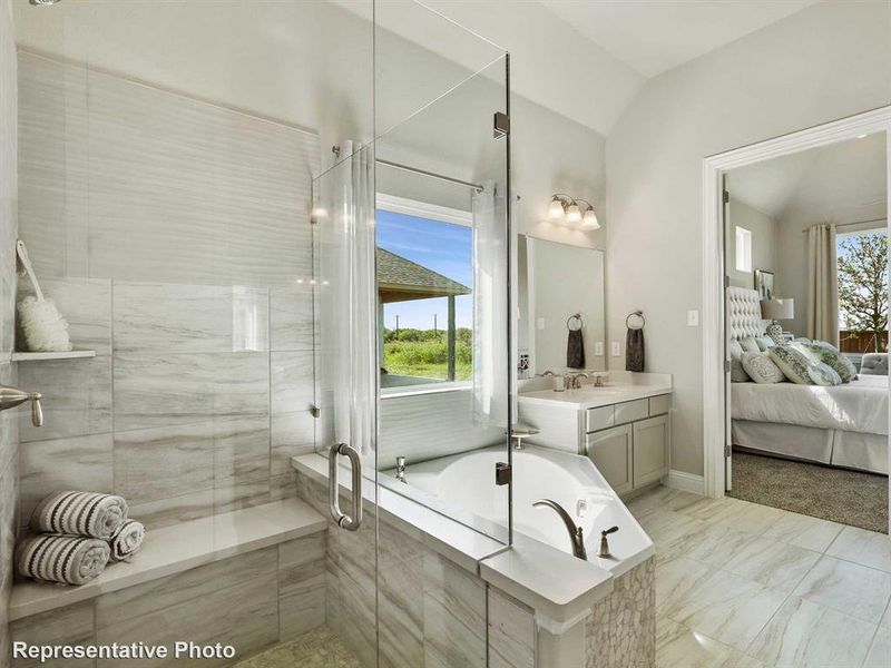 Bathroom featuring a glass-enclosed shower, a built-in shower bench, a corner soaking tub, a double vanity with an undermount sink, and tile flooring