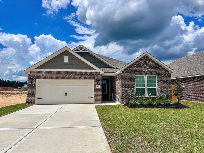 Front exterior of a new home in Magnolia Woods, Magnolia, TX, highlighting curb appeal (Image 1).
