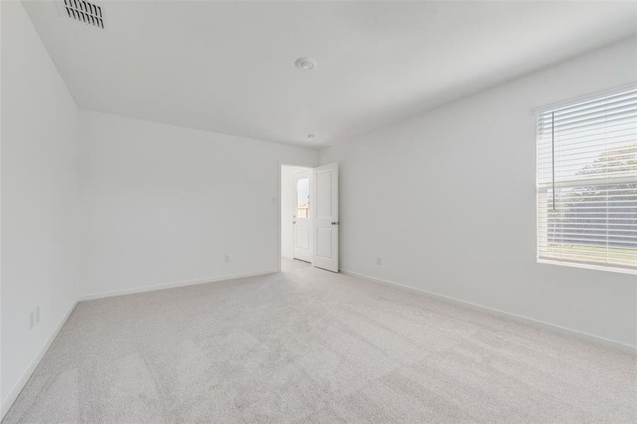 Spare room with light colored carpet