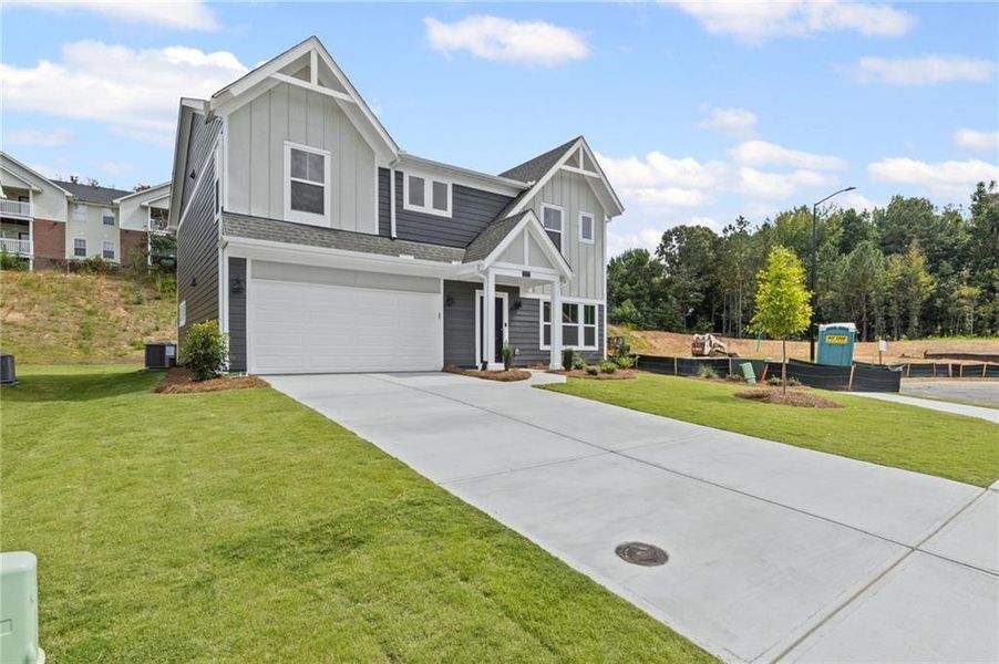 Front exterior of a new home in Sage Woods, Dallas, GA, highlighting curb appeal (Image 1).