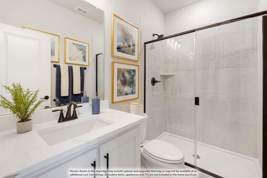 Bathroom with white vanity, glass-enclosed tile shower, and dark bronze fixtures