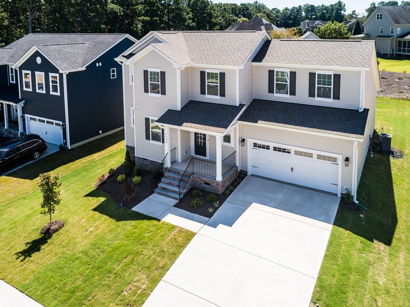 Front exterior of a new home in High Grove Oaks, Fuquay Varina, NC, highlighting curb appeal (Image 22). Front exterior of a new home in High Grove Oaks, Fuquay Varina, NC, highlighting curb appeal (Image 22).
