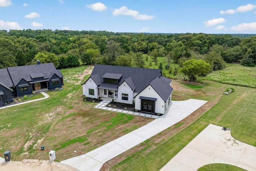 Aerial view of property and surrounding area featuring a heavily wooded area Aerial view of property and surrounding area featuring a heavily wooded area